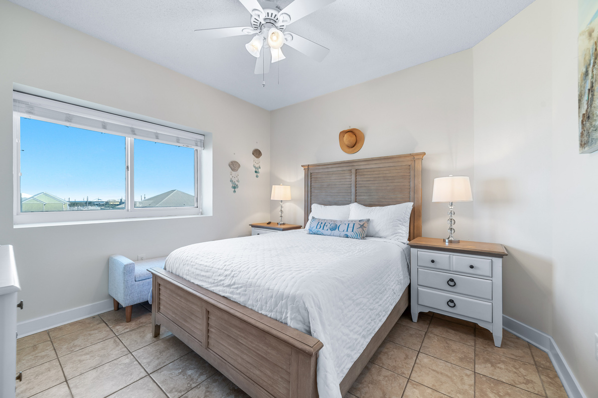 Discover the calming ambiance of the third guestroom, featuring a neutral color scheme and plush bedding for ultimate comfort.