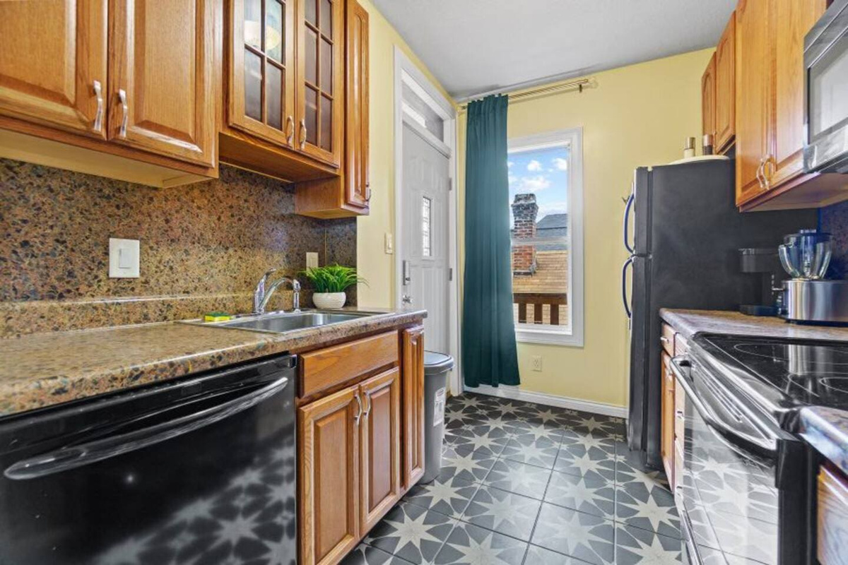 Spacious kitchen with ample cabinets, offering plenty of storage and counter space for cooking and meal prep.