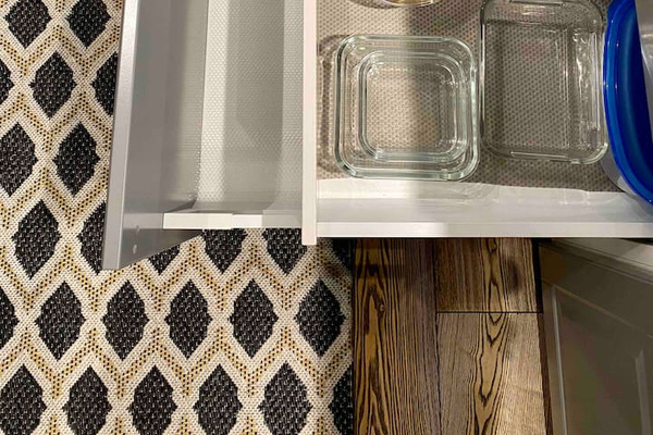 Kitchen Island.
Second drawer on the left has.
1. Top one has containers
2. Is empty