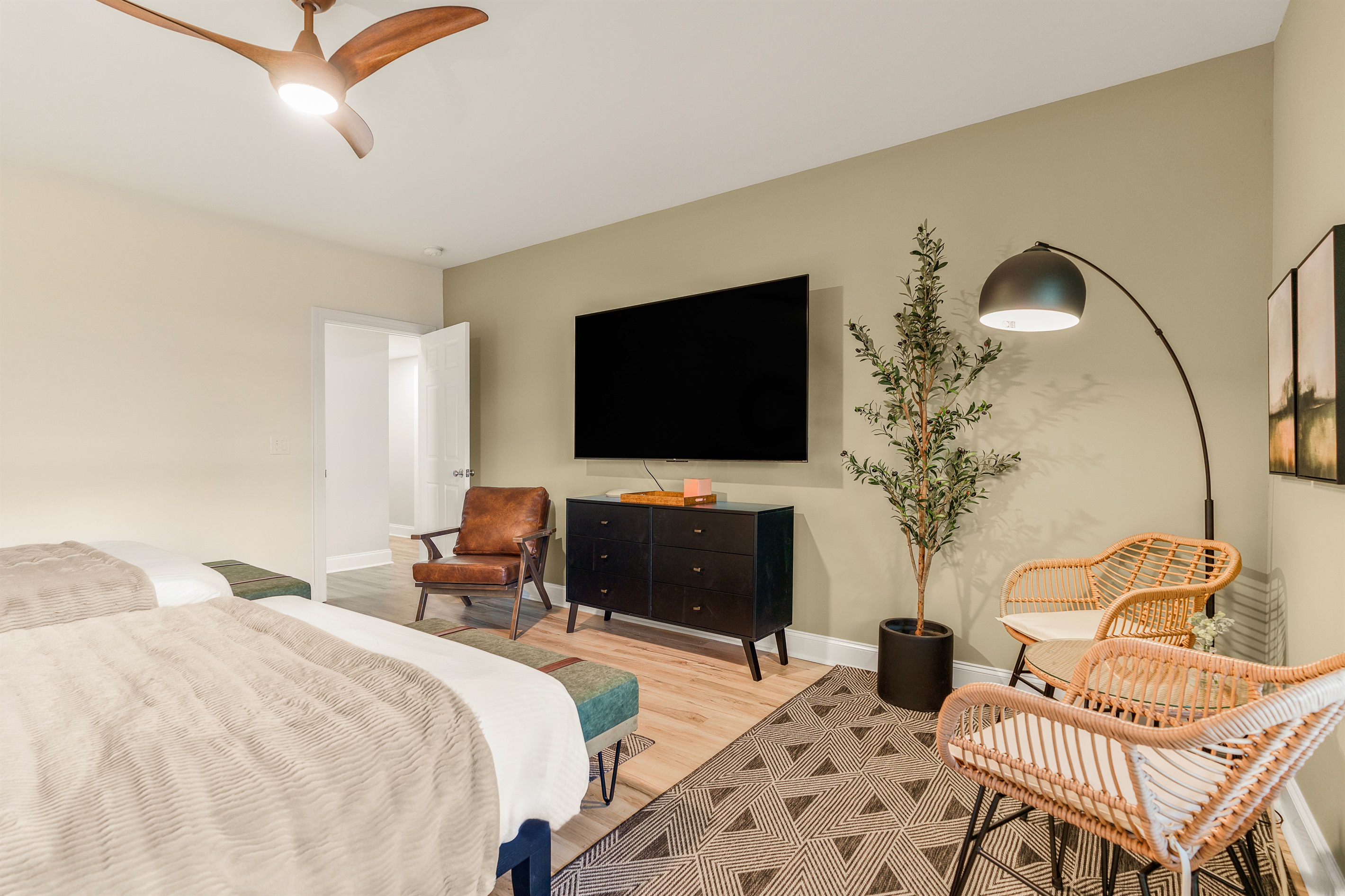 Sip coffee, journal, or catch up on work in this serene corner nook—a cozy perch beneath soft light, balanced by a 75" smart TV and warm, earthy textures throughout