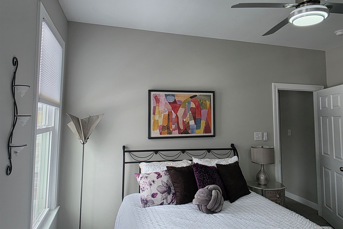 Queen Bedroom 3: Relax on a plush bed adorned with vibrant pillows and gentle natural light