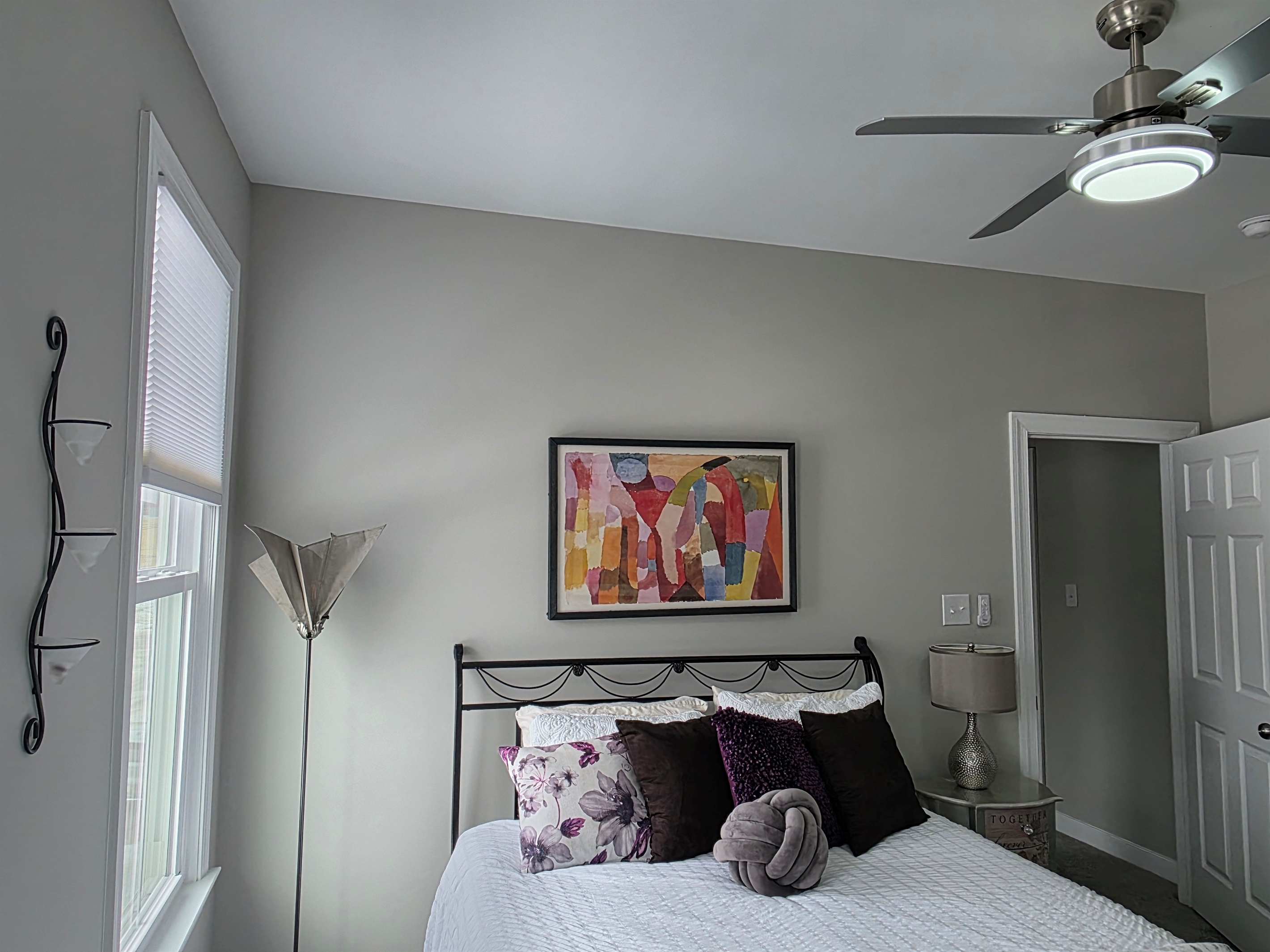 Queen Bedroom 3: Relax on a plush bed adorned with vibrant pillows and gentle natural light