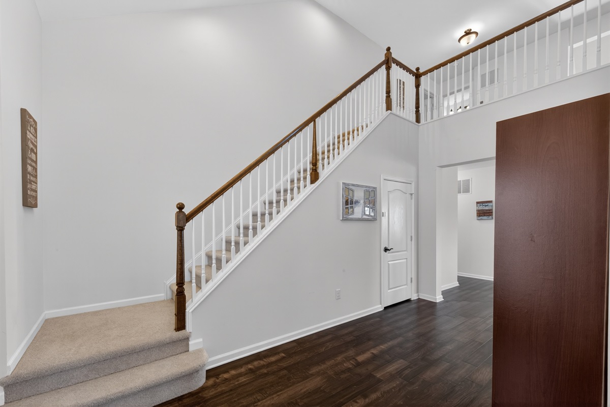 Open entry with full coat closet, bench and shoe rack.