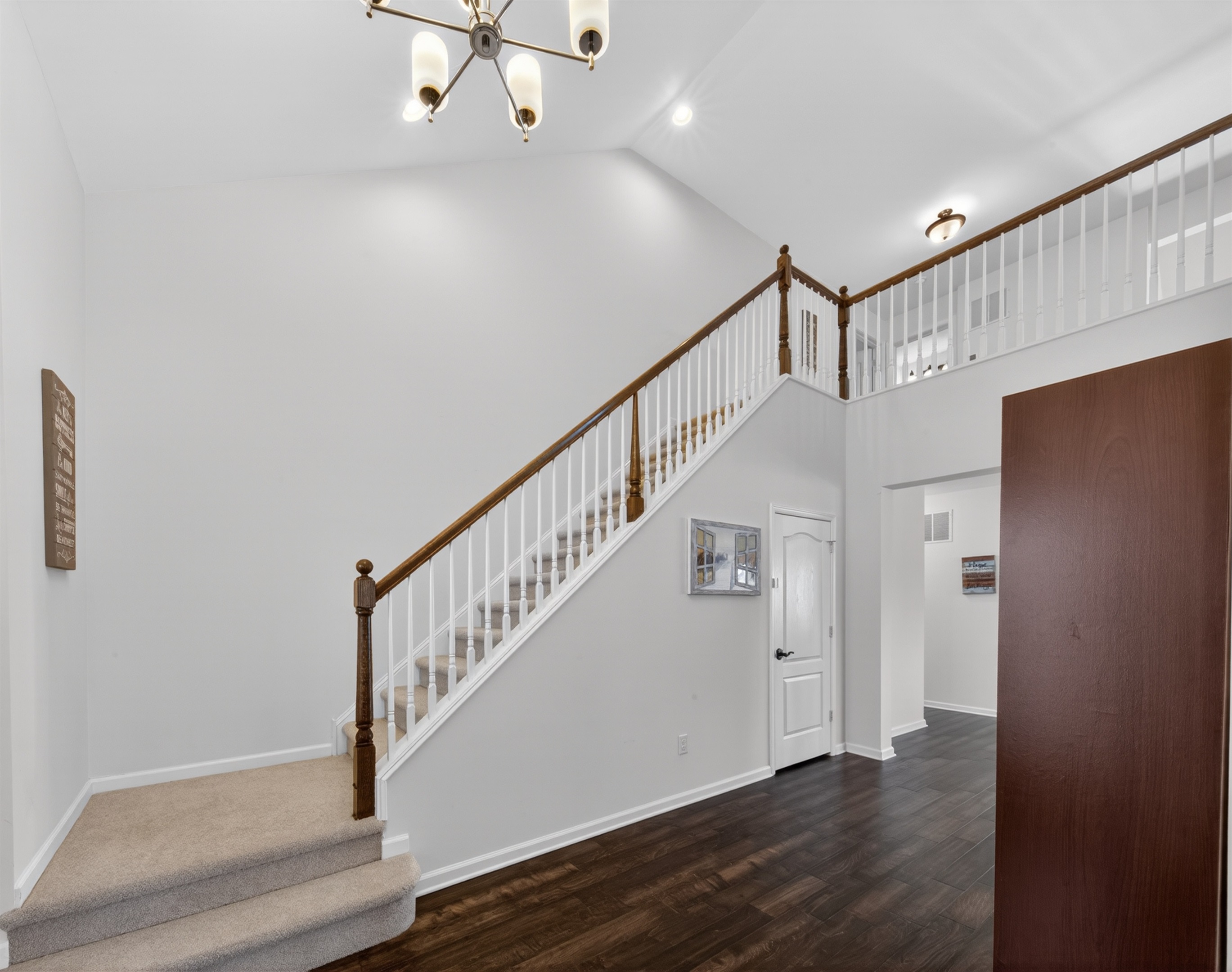 Open entry with full coat closet, bench and shoe rack.