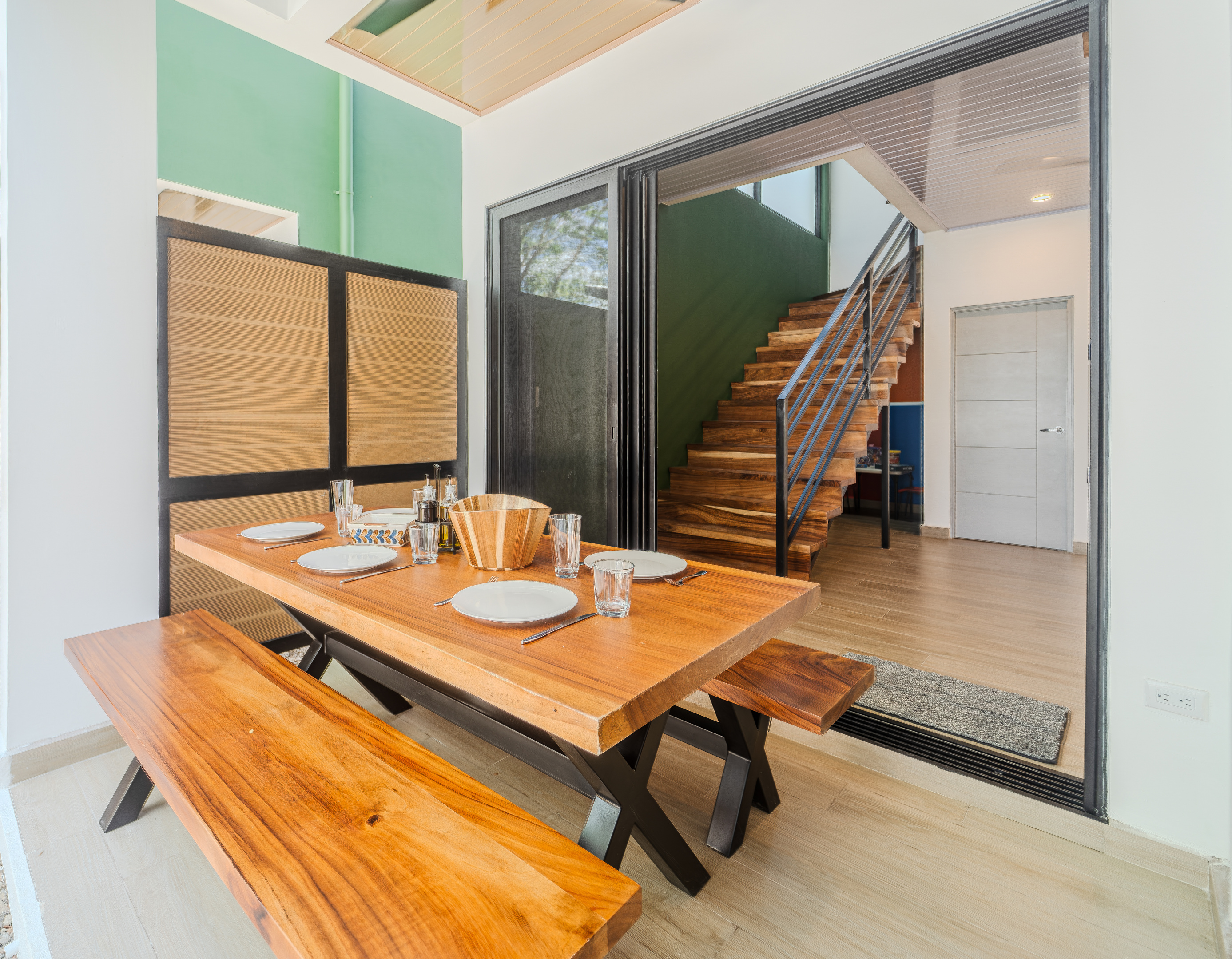 Outdoor dining under a covered roof that seats six. The dining area connects kitchen, terrace, and living room. The heart of the home