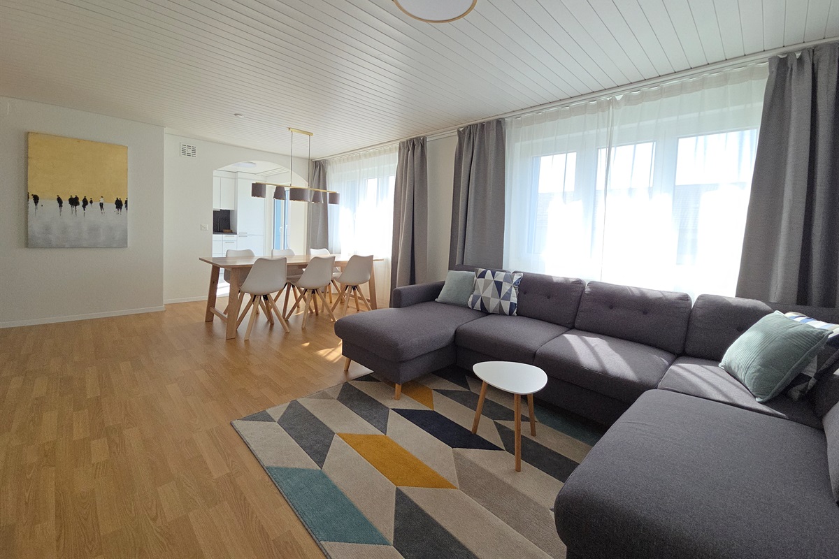 The living room and dining area is right next to the modern kitchen