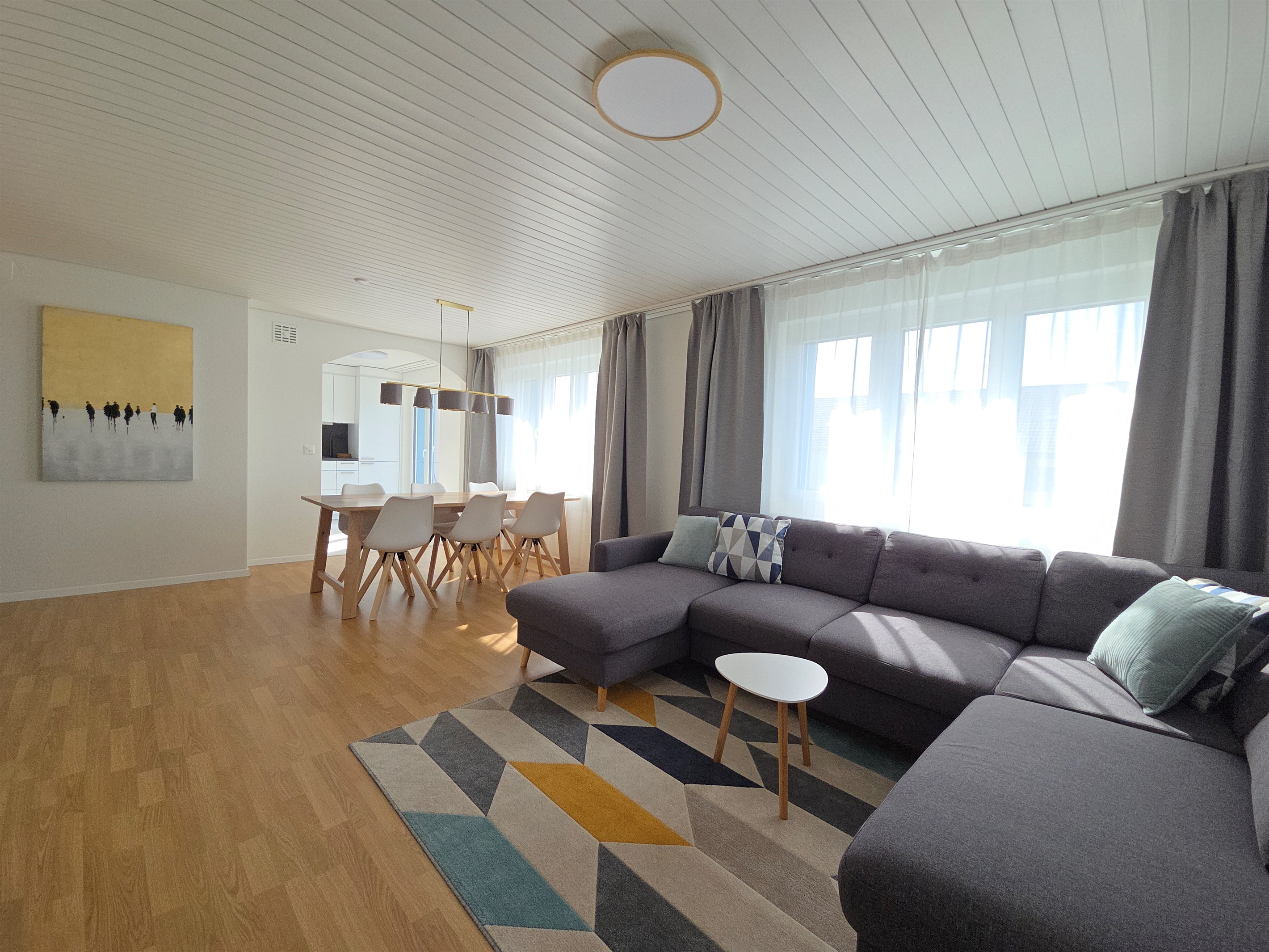 The living room and dining area is right next to the modern kitchen