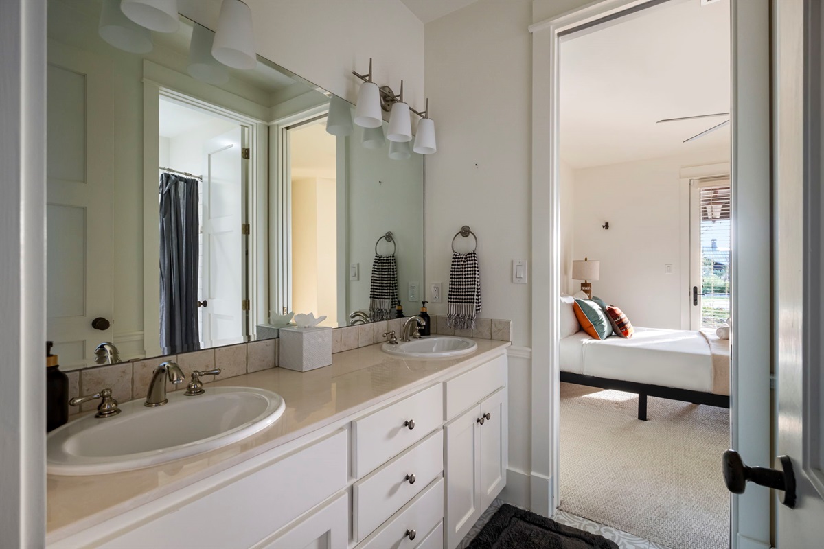 Start your day refreshed in our bright, dual-sink bathroom, conveniently located next to a cozy bedroom for ultimate comfort and privacy