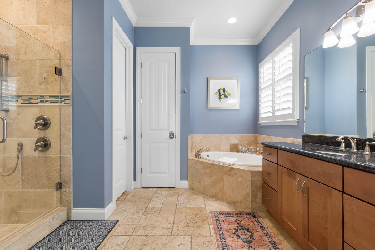 Glass walk-in shower and a corner soaker tub in the Primary bath, so you can rinse off quickly or take a long soak.