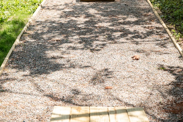 Move the cornhole boards aside to reveal the horseshoe pegs underneath.