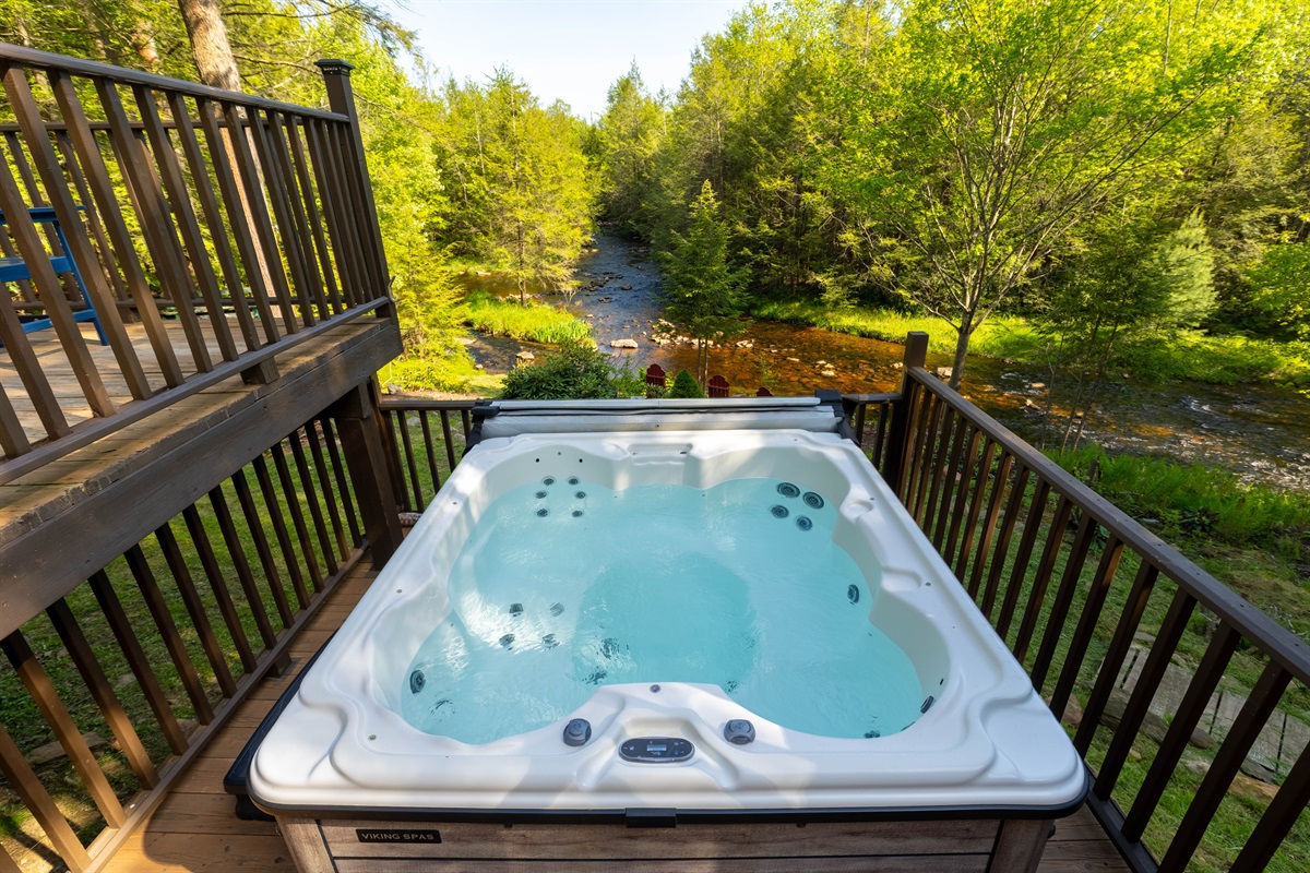 Unwind in the private hot tub while listening to the river flow just beyond the deck.