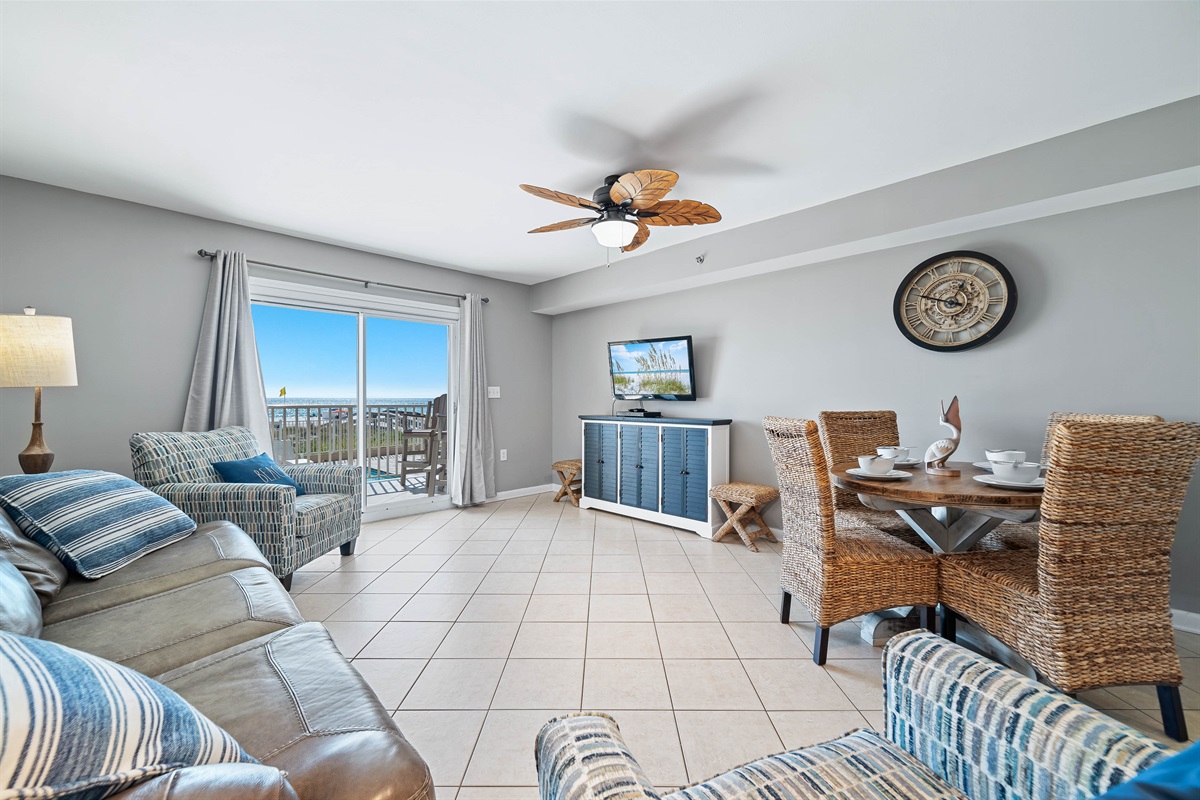 Bright and airy living area with a stunning view of the water. The space is complete with a comfortable sleeper sofa, perfect for relaxing after a day at the beach.