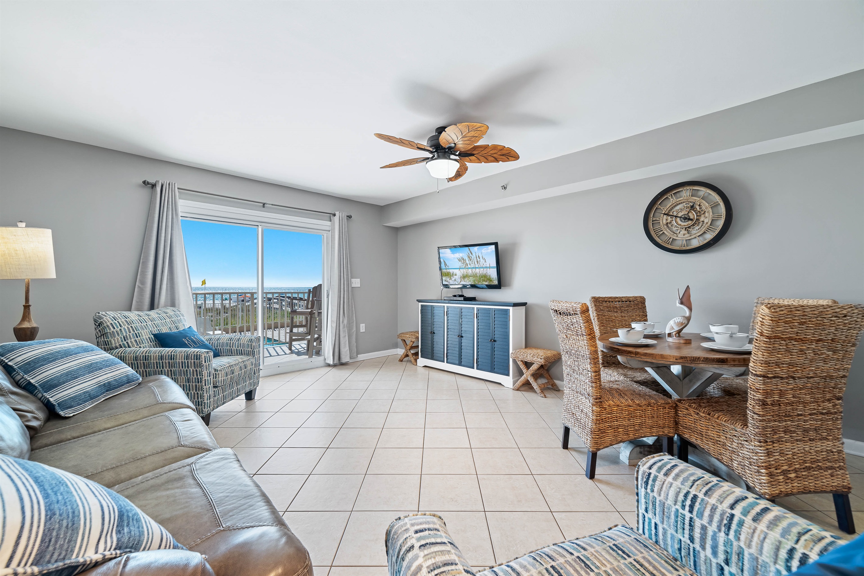 Bright and airy living area with a stunning view of the water. The space is complete with a comfortable sleeper sofa, perfect for relaxing after a day at the beach.