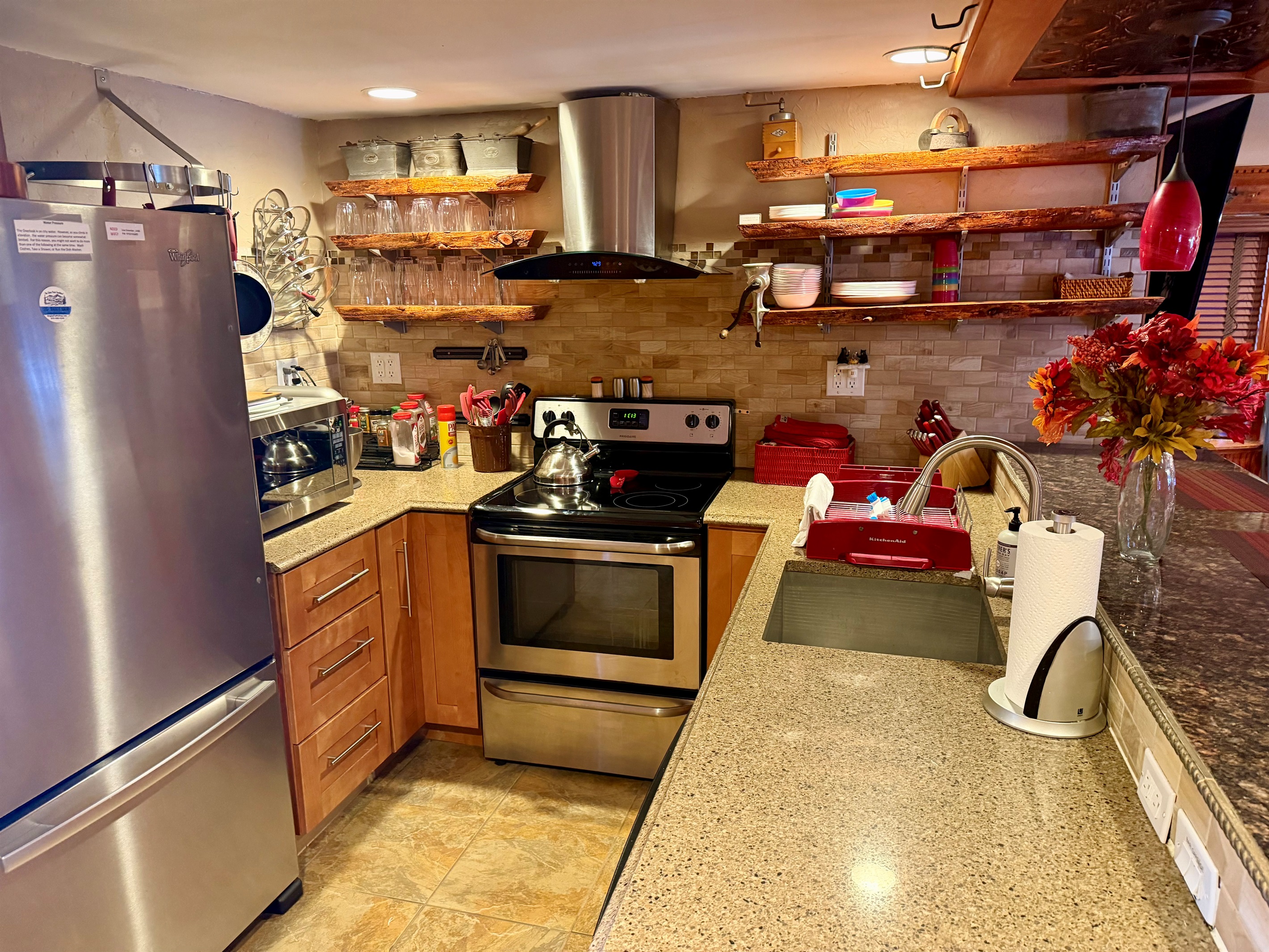 Well appointed kitchen with stainless appliances, cookware, and heated floors for cozy mornings.