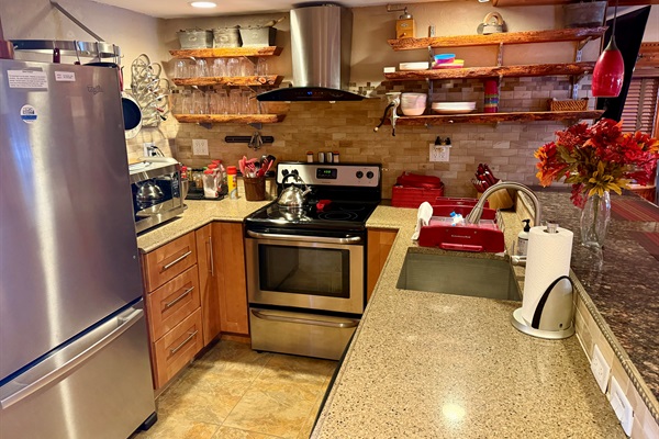 Well appointed kitchen with stainless appliances, cookware, and heated floors for cozy mornings.