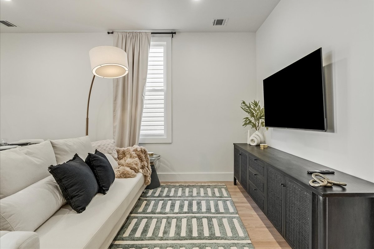 Comfort meets style—glam couch with a high-tech TV experience.