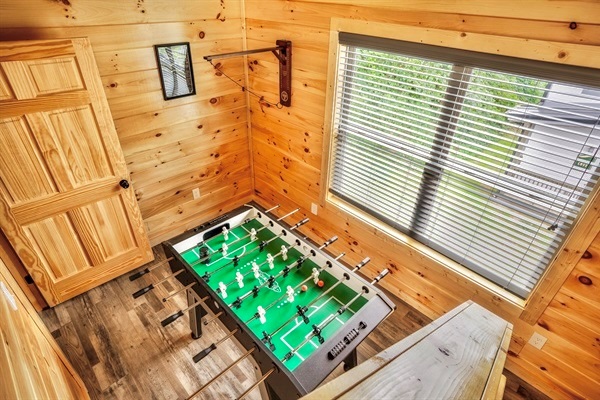 Dive into a world of endless entertainment in our game room, where you'll find a foosball table, a mini Pac-Man arcade machine, board games, children's literature, and an engaging ring toss wall game.