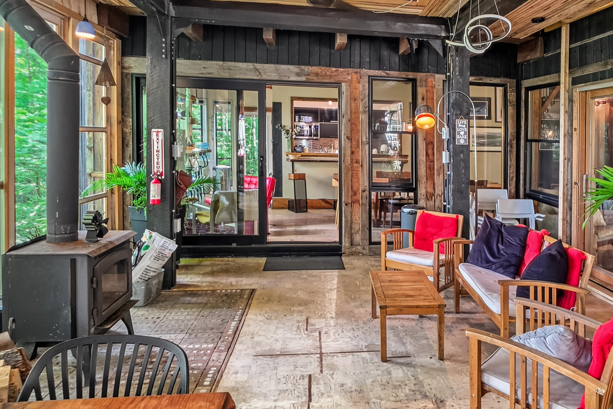 Veranda wood stove and seating area at cottage side door