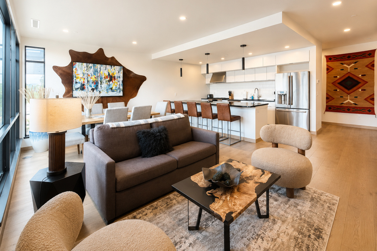 Main living space with open modern living room and kitchen. The living room features a luxury full sofa sleeper.