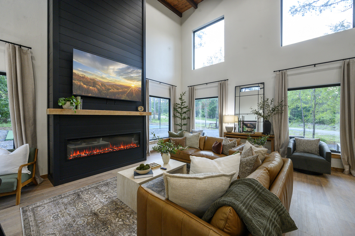 Warm leather seating, oversized windows and a dramatic black fireplace, creating a polished space for movie nights, quiet mornings and everything in between.