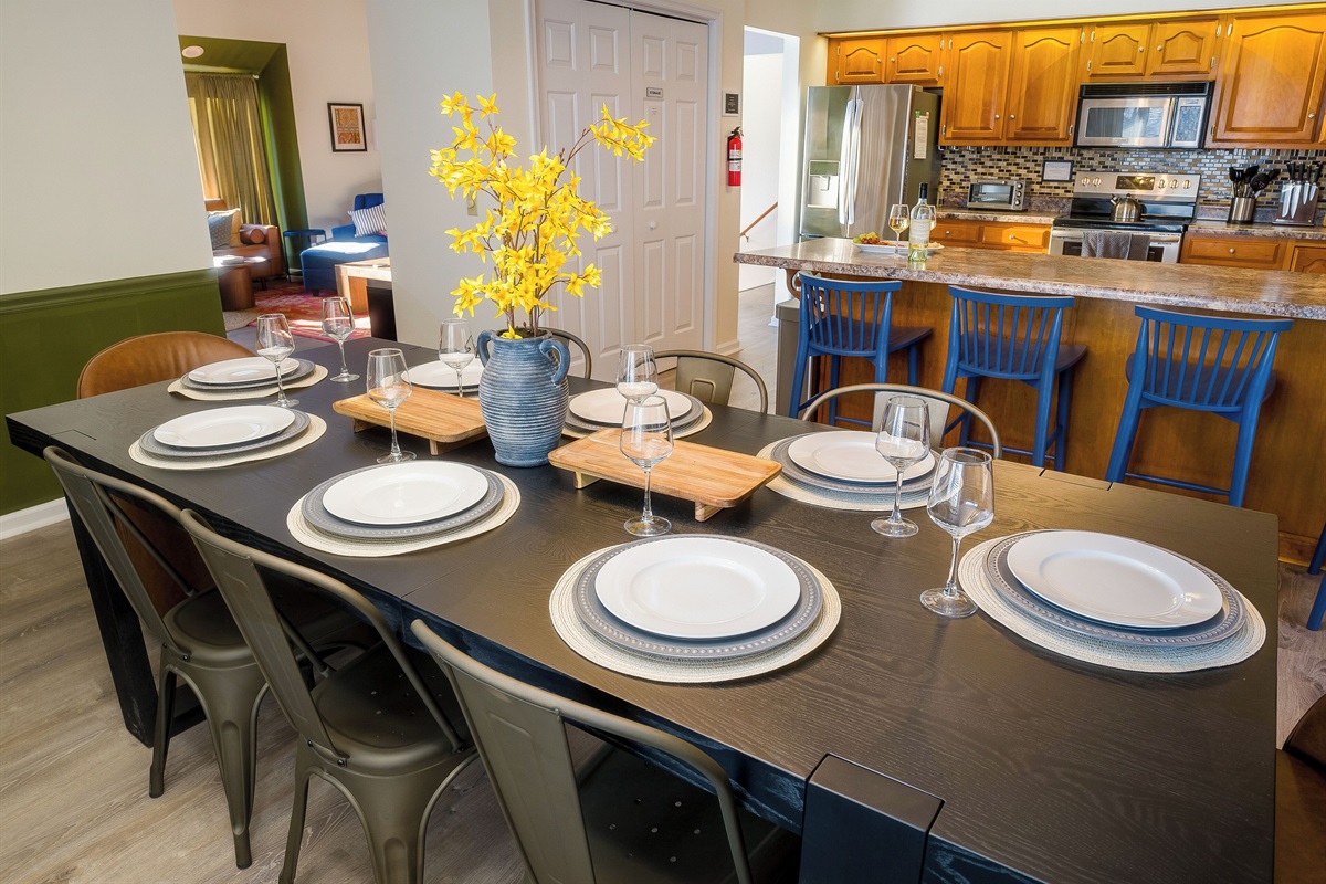 Dining large enough for 10 (even though this is set for 8) 2 other chairs are there.  And the bar seats 4.  High chair available in the queen bedroom closet