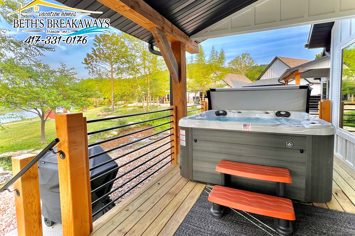 The back porch provides a relaxing hot tub, seating, and your own private grill!