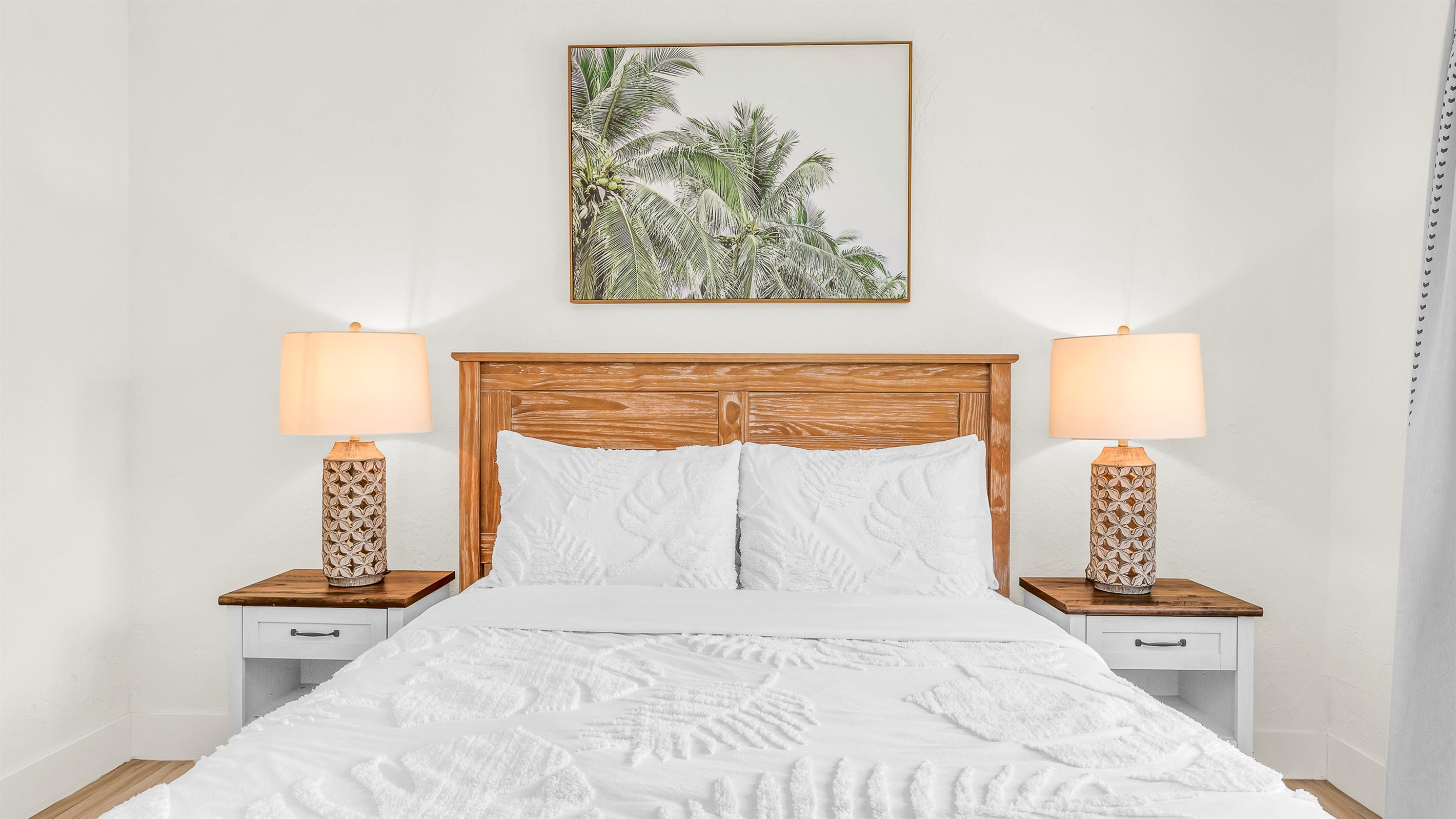 Bedroom 2 offers a relaxing coastal vibe with crisp linens, warm natural light and elegant decor- perfect for guests seeking comfort and tranquility after a day in paradise