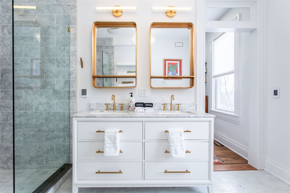 Bathroom cabinet, sink, and mirrors.