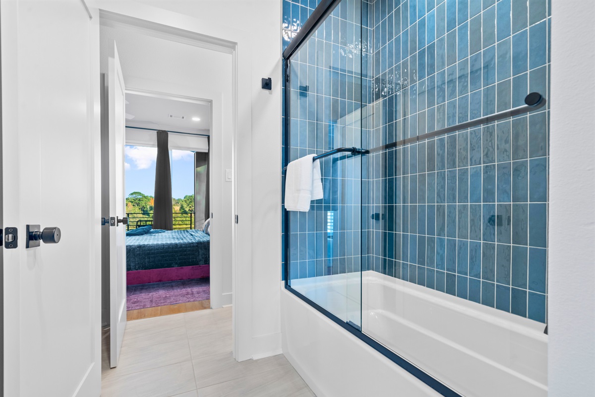 Clean and modern, this bathroom has beautiful tiling and fresh design elements that add a touch of sophistication.