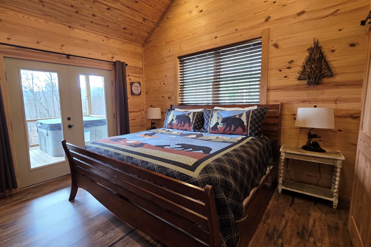 King bed with access to the covered porch and hot tub
