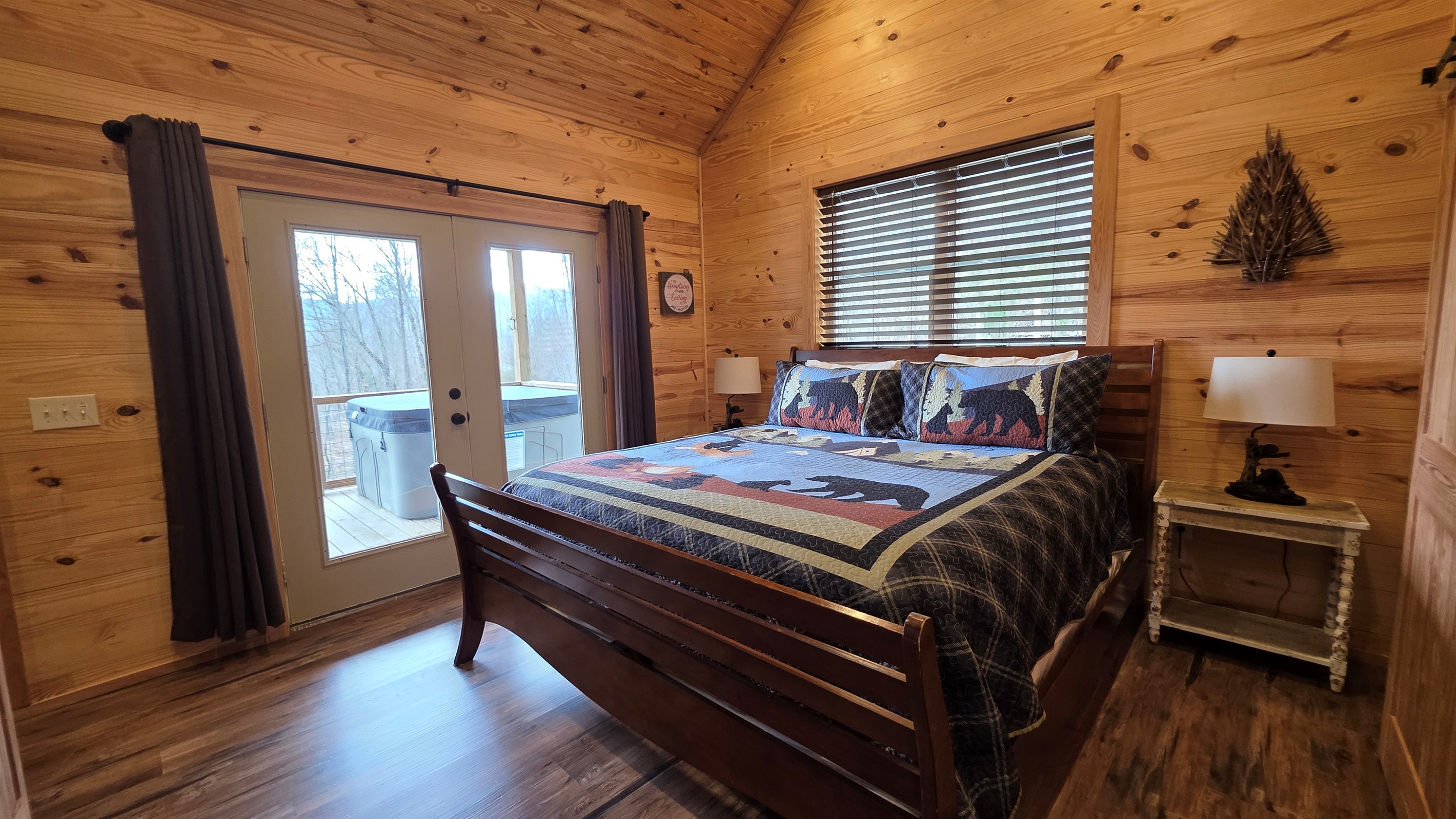 King bed with access to the covered porch and hot tub