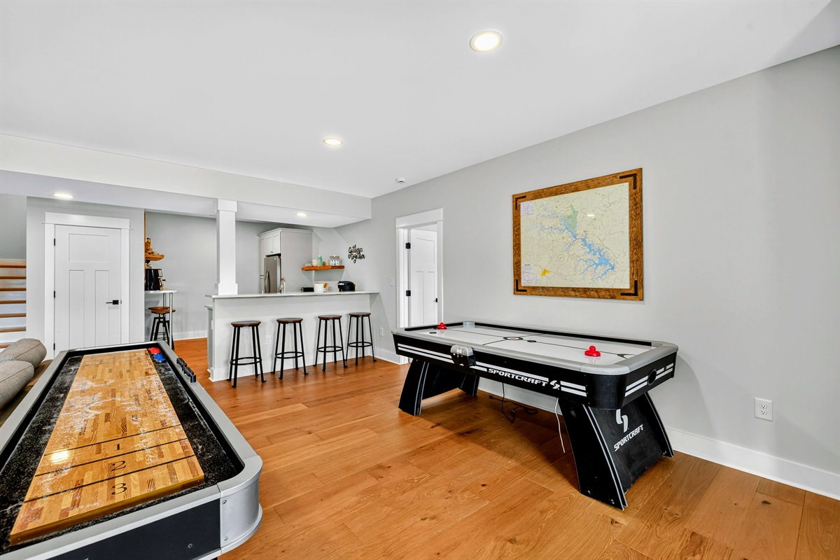The lower level is unique as it offers a separate living space for families who are vacationing together with a kitchen, two king suites, quad bunk room, game room, arcade, shuffleboard, air hockey, coffee bar.