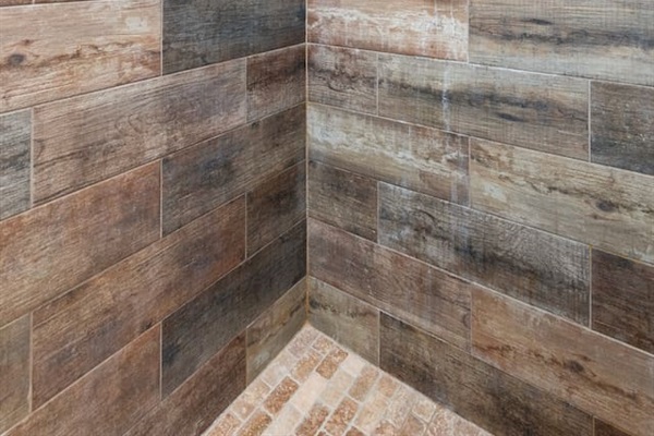 Step into this stylish full bathroom featuring a spacious walk-in shower with custom wood-look tile and frameless glass door for a spa-like experience.

