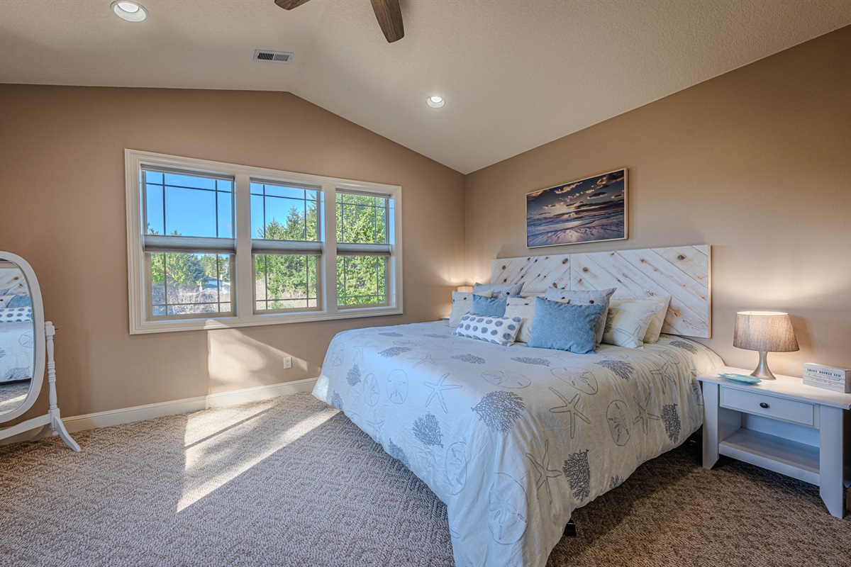 Primary bedroom with King size memory foam mattress and 50" smart TV