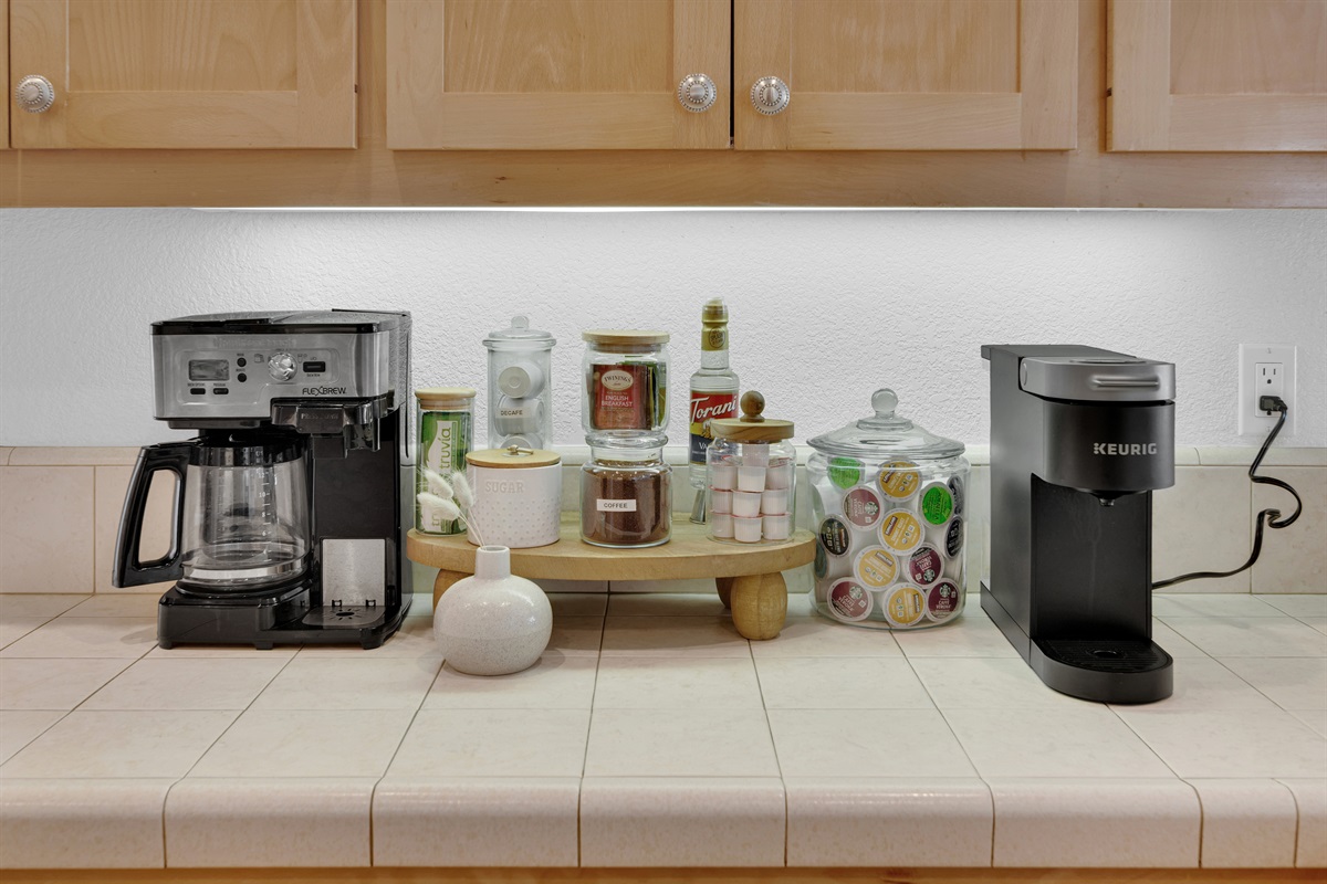 Deluxe coffee station includes Keurig and 12-cup coffee pot options. Coffee pods, de-café, sugar, creamer, and an assortment of teas are offered complimentary.