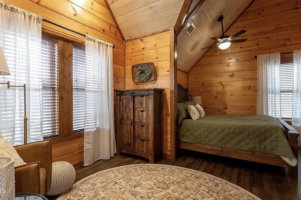Unwind in the spacious king master bedroom at Marigold Cabin, a 3-bedroom, 3-bathroom vacation rental in Pigeon Forge, TN. Featuring plush bedding, warm cabin d&eacute;cor, and all the comfort you need for a restful night in the Smoky Mountains. 