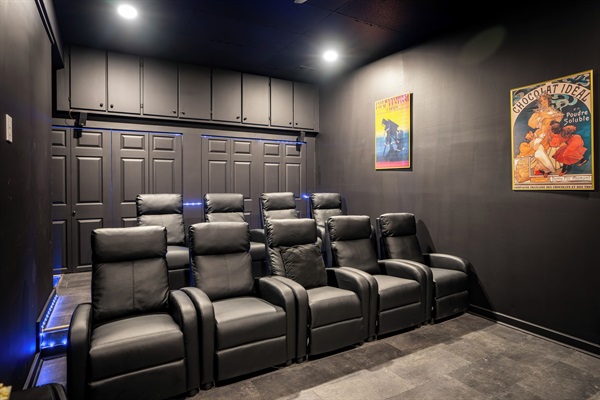 Theater room with big screen smart TV and seating for 9
