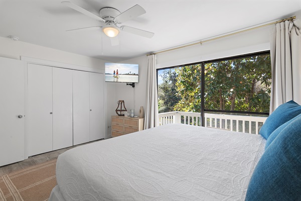 Cozy Coastal Chic Master Bedroom: Unwind in the master bedroom with a luxurious king-sized bed, private bath, and a balcony offering serene views — ideal for morning coffees.