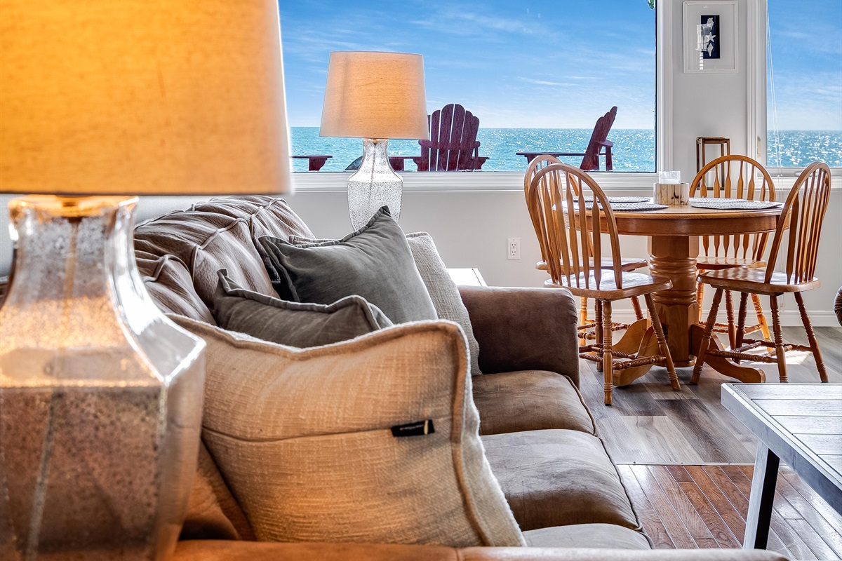 Sun-soaked living room with wall-to-wall lake views