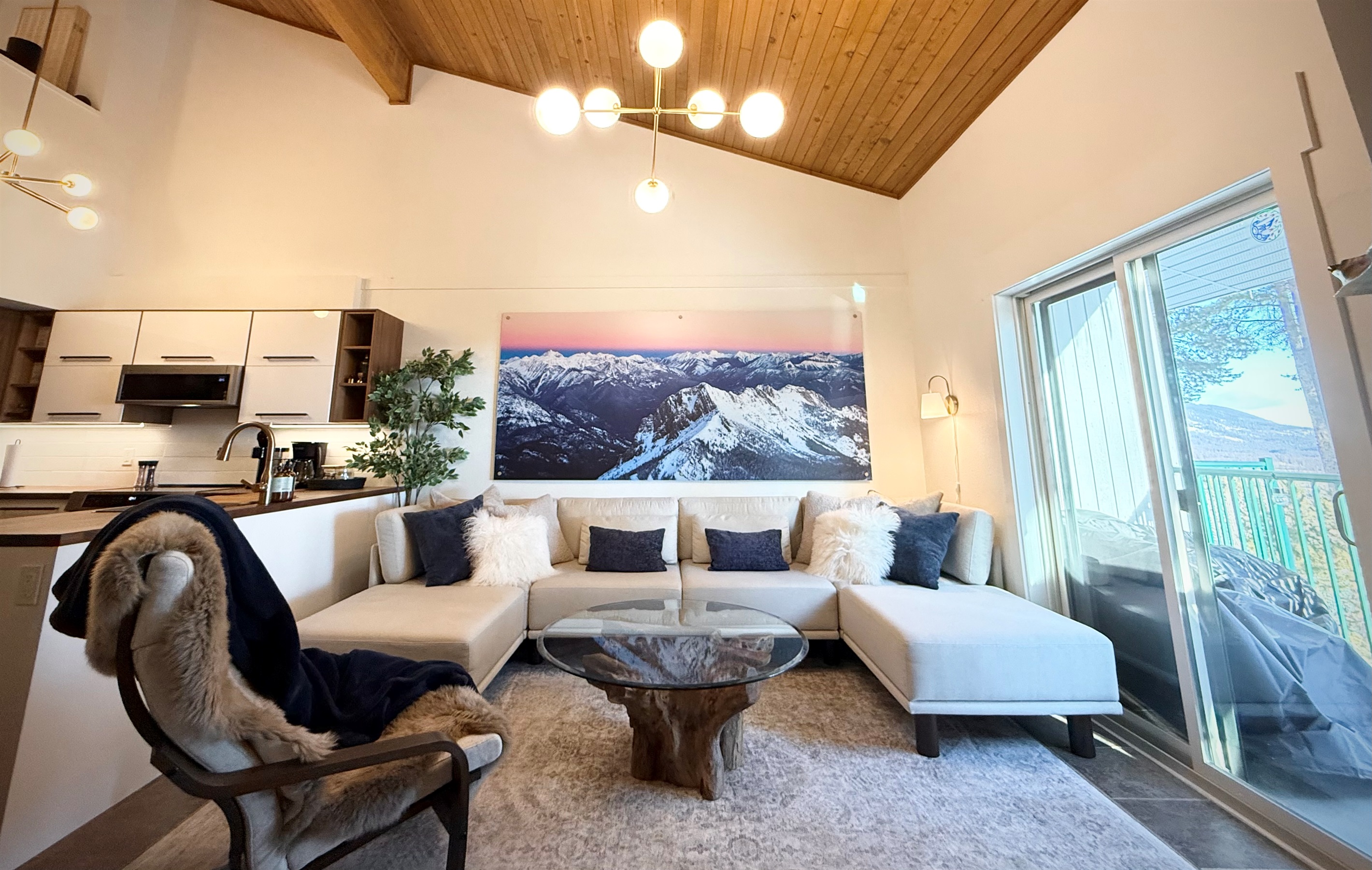 Vaulted Ceilings: The main living area features impressive vaulted cedar ceilings, a cozy gas fireplace, and ample seating on the deep-seated sofa for maximum relaxation.