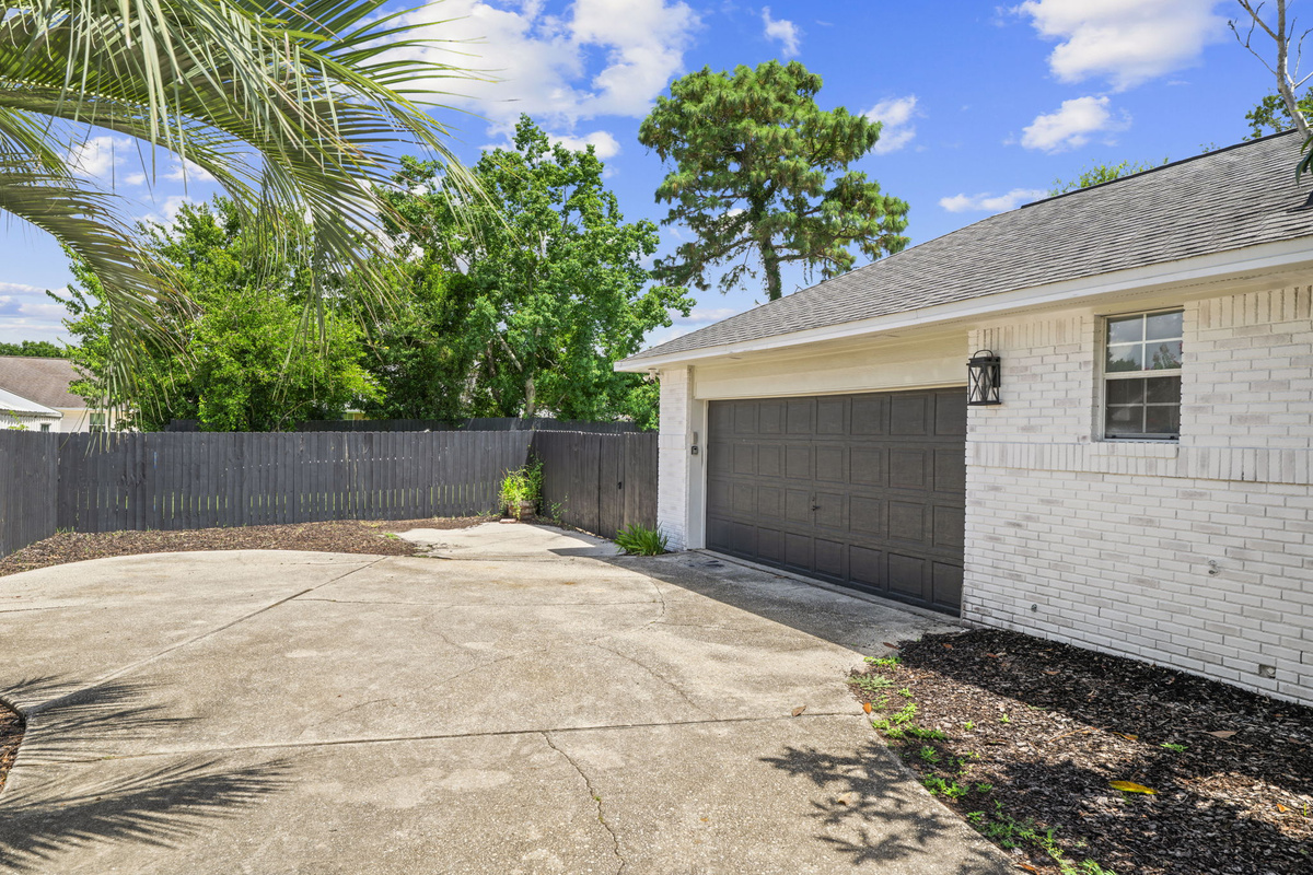 Ample parking with a two-car garage, tucked beside swaying palms for that true Florida feel.