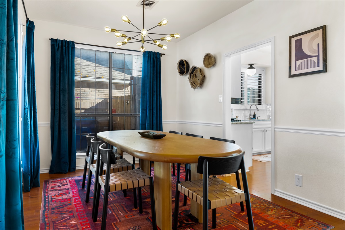 Spacious dining area featuring eight cozy chairs and windows bathing the room in sunlight.