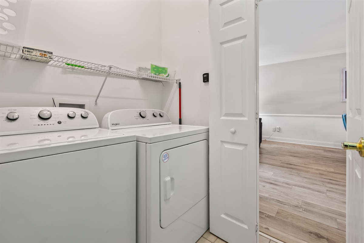 A well-organized laundry room equipped with modern appliances, ample storage, and a clean, functional design—making laundry tasks easy and efficient in a neat and tidy space