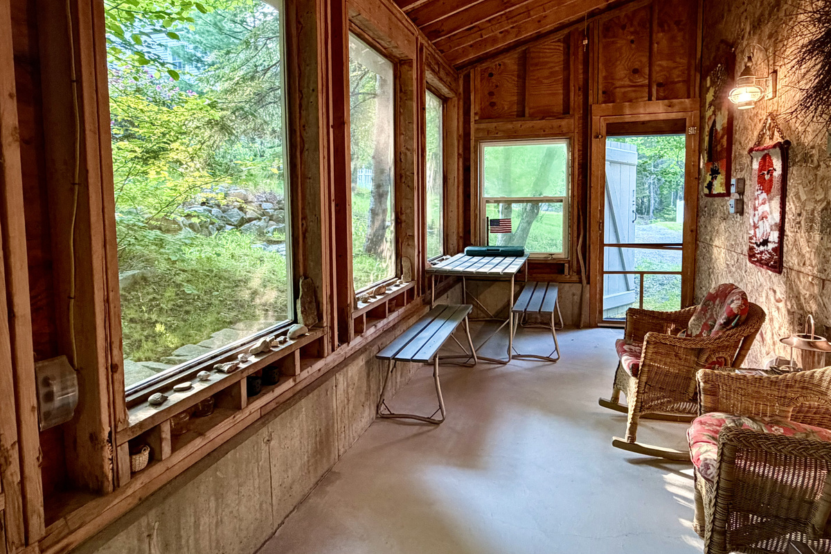 A reverse view of the Settler's Sidecar highlights a classic indoor picnic table. This versatile setup offers the perfect dedicated station for family board games, afternoon puzzles, and snack spreads out in the fresh island air.