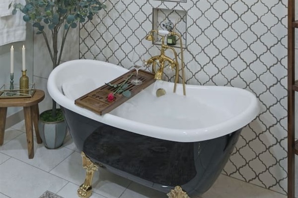 Sophisticated clawfoot tub under a statement chandelier, creating a serene and elegant space to unwind
