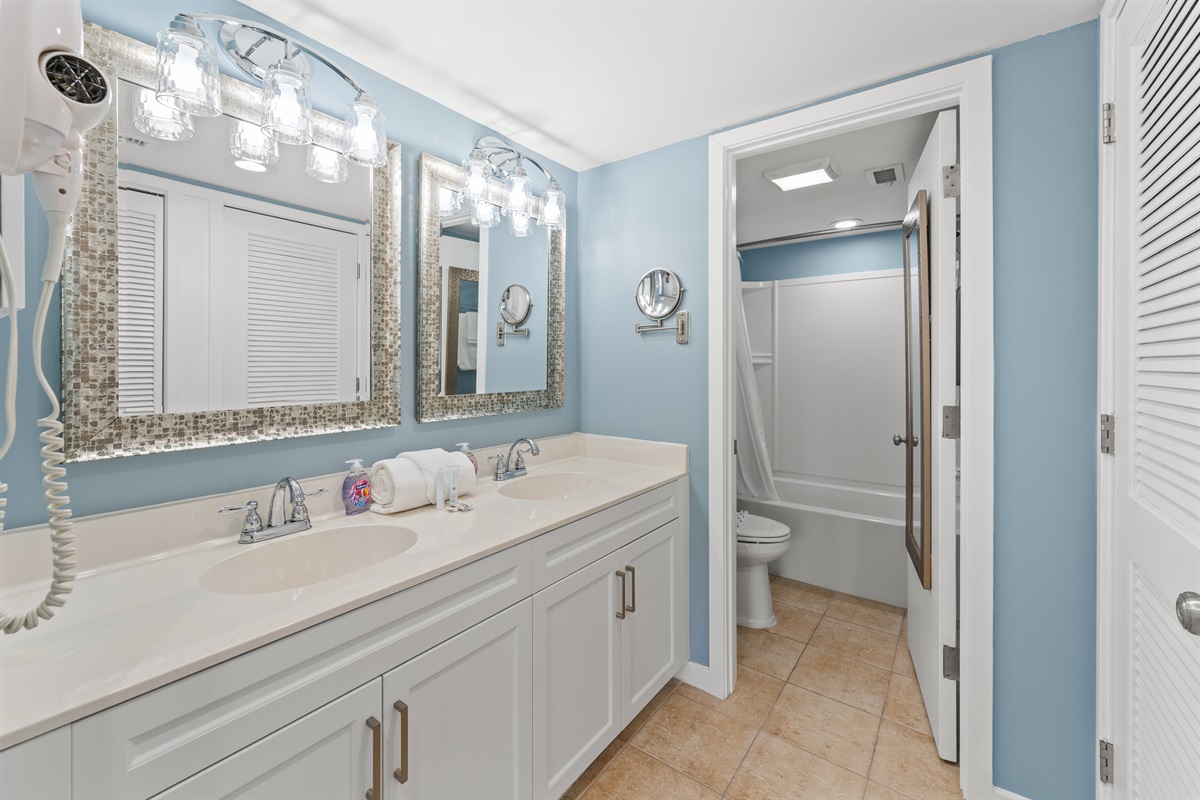 Main Bathroom with double sinks and tub/shower combo