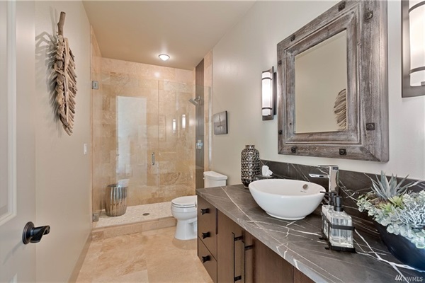 Downstairs bathroom featuring a vessel sink and walk-in shower.