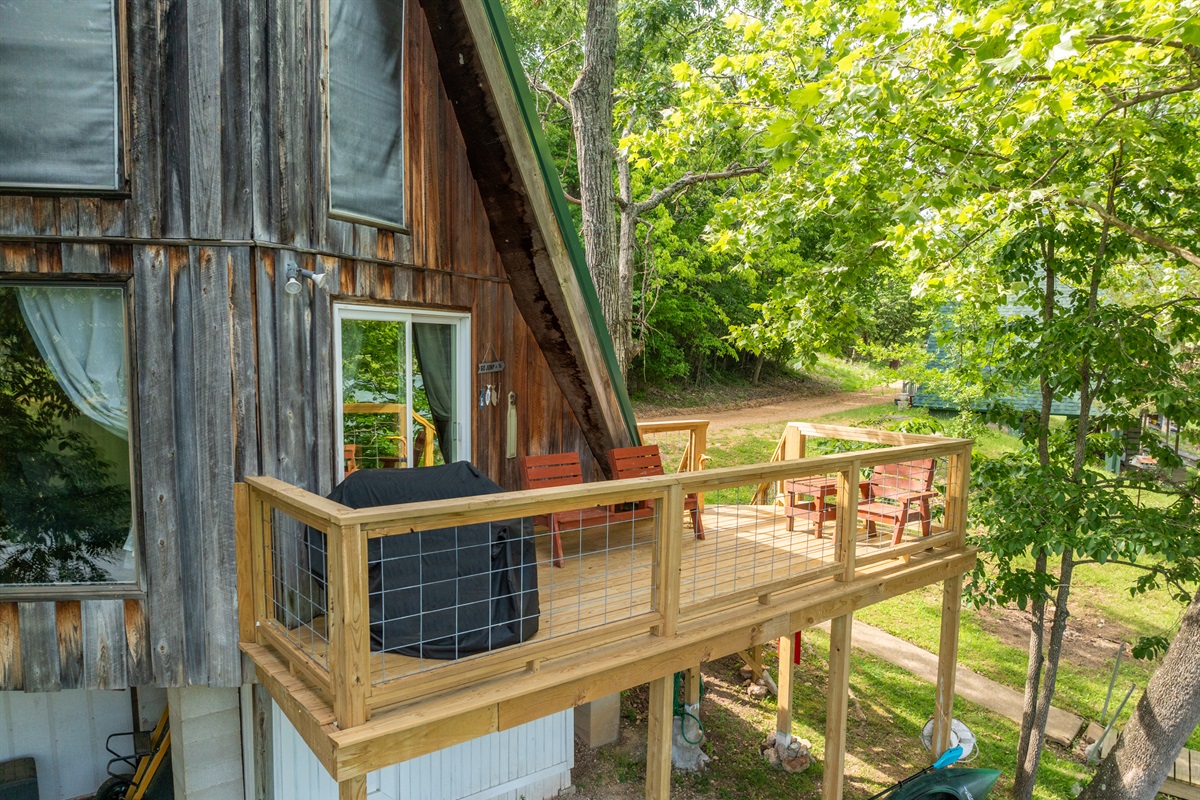 Back deck includes nice seating area and charcoal grill.