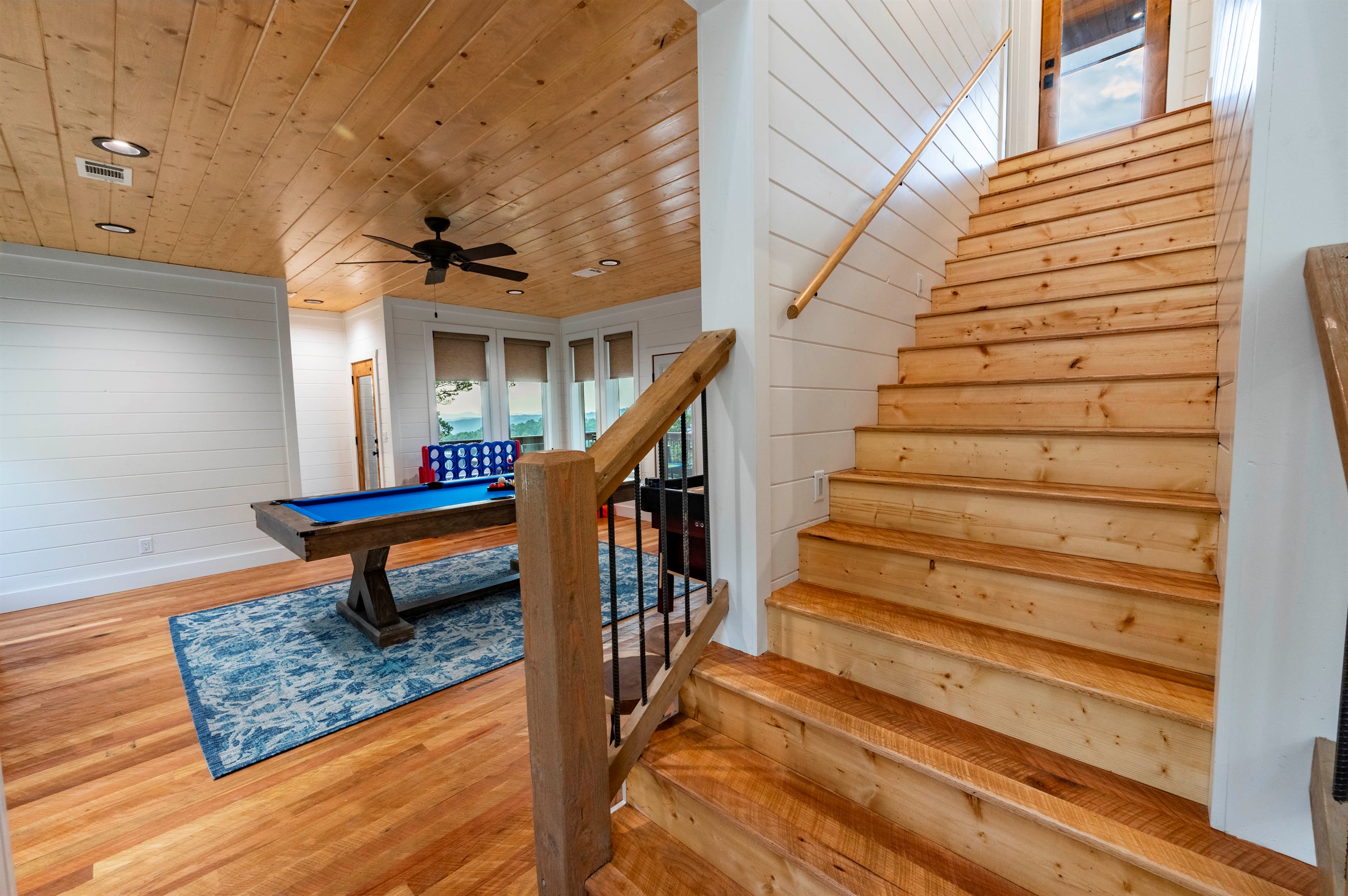 Spacious upper-level game area with handcrafted wood details and open cabin charm