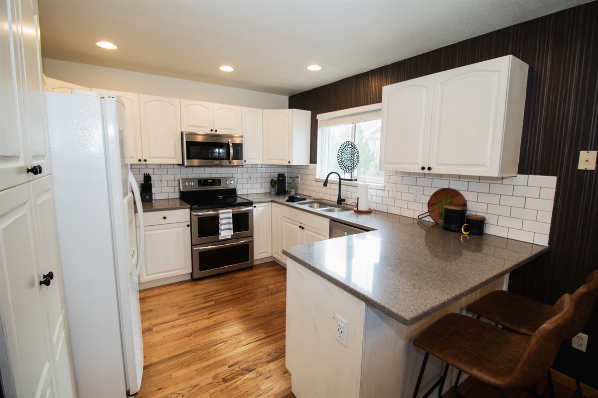 Warm kitchen stocked with coffee, flour, spices, cooking oil, and all of the essentials! All you need are the groceries.